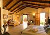 Guesthouse 1 with two Queen beds, TV and bathroom at Casa Milagro beachfront vacation rental house in Jaco, Costa Rica