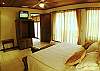 Master Bedroom with ensuite bathroom, TV and armoire at Hermosa Palms Casa McDermott vacation rental house in Playa Hermosa, Puntarenas, near Jaco, Costa Rica