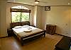 Second bedroom with King size bed and shared bathroom at Villa Las Monas vacation rental house near Jaco, Costa Rica