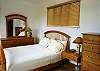 Bedroom 2 with a view of the rainforest, Queen bed and closet, at Casa Infinito luxury vacation rental home at Valle Perdido in Playa Hermosa, Costa Rica