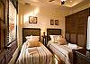 Firth bedroom with two Twin beds, TV and closet, in the guesthouse at Hermosa Palms Villa La Costa luxury vacation rental in Playa Hermosa, Costa Rica.