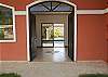 Main house entrance from within forecourt within the property.  The swimming pool can be seen beyond the living area at Casa Las Monas vacation rental house near Jaco, Costa Rica