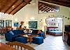 Comfortable living area with TV with Master Bedroom in the back at Casa Milagro beachfront vacation rental villa in Jaco, Costa Rica