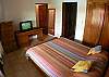 First Bedroom with Queen bed, TV, closet, dressers and ensuite bathroom at Rio Copey vacation rental in Jaco, walking distance to beach and main street.
