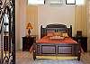 Master Bedroom (ground floor) with King bed, ensuite bathroom, walk-in closet, safe and 40 inch LCD TV, that opens to the courtyard at Villa Antigua luxury vacation rental home in south Jaco beach, Costa Rica
