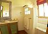 Ensuite bathroom within Bedroom 4, with combination shower/jetted bathtub and tempered glass door at Villa Oceana vacation rental home in Esterillos, Costa Rica, halfway between Jaco and Manuel Antonio.
