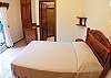 Bedroom overlooking the pool area with Double bed, closet and ensuite bathroom at Casa Miguel vacation rental in Jaco, Costa Rica, 8 minutes walking distance to beach and main street.