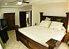 This is the Main Bedroom with king bed, Ac and TV at La Flor beachfront gated community on the North side of Jaco beach Costa Rica