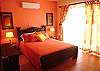 View of one of the three upstairs bedrooms, with double bed, closet, AC and access to the terrace.