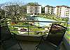 View of the pool area and gardens from the balcony at Costa Linda 3-20 vacation rental condominium Jaco Costa Rica