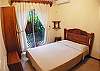 Bedroom overlooking the garden, with Double bed, closet and ensuite bathroom at Casa Miguel vacation rental in Jaco, Costa Rica, 8 minutes walking distance to beach and main street.