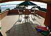 Large outdoor ocean view Terrace with table, chairs, large umbrella and lounge chairs at our MarArena beachfront vacation rental penthouse condo in Jaco, Costa Rica