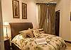Second bedroom with Queen bed, black-out curtains, closet and ensuite bathroom at Hermosa Palms Villa La Costa vacation luxury rental in Playa Hermosa, Costa Rica