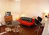 Living area with dining table, TV and sofabed within Apartment 2 at Casa Gris vacation rental home in Jaco, walking distance to the beach and center.