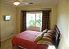 Bedroom 3 with Queen bed, TV, closet and black-out curtains, at Del Mar 5N vacation rental condo at Los Suenos Resort & Marina, Playa Herradura, Costa Rica