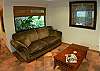 Living area with comfortable fabric couch and coffeetable at Casa Colonial at Hermosa Palms gated community in Playa Hermosa, Costa Rica