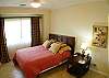 Bedroom 3 with Queen bed, TV, closet and black-out curtains, at Del Mar 5N vacation rental condo at Los Suenos Resort & Marina, Playa Herradura, Costa Rica