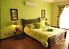 Master bedroom :Queen bed and black-out curtains  at La Flor Rustico beachfront vacation rental in Jaco, Costa Rica