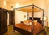Gorgeous Master Bedroom with King size four poster bed with canopy, high vaulted ceiling, black-out curtains, armoire with TV and DVD, overlooking the ocean, at Hermosa Palms Villa La Costa vacation luxury rental in Playa Hermosa, Costa Rica