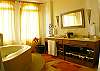 Master bathroom with double sink, granite countertop, jetted bathtub with shower and walk-in closet at Casa Exotica vacation rental home in Esterillos, Costa Rica near Manuel Antonio and Jaco.