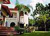 View of house and garden from the entrance at Villa Antigua luxury vacation rental near the beach in Jaco, Costa Rica