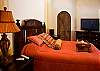 Master Bedroom (ground floor) with King bed, ensuite bathroom, walk-in closet, safe and 40 inch LCD TV, that opens to the courtyard at Villa Antigua luxury vacation rental home in south Jaco beach, Costa Rica