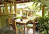 This is the outside dining room, with a beautiful view of the pool area and gardens at Sonidos del Mar, Vacation Rental, Jaco Costa Rica.