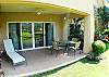 Terrace with table, chairs and lounge chair at Los Suenos Del Mar 5N vacation rental luxury condominium in Playa Herradura, Costa Rica