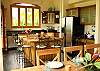 Large gourmet kitchen with breakfast island with cushioned stools and stainless appliances at Casa Exotica vacation rental home in Esterillos, Costa Rica, near Manuel Antonio and Jaco