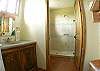 Bathroom with shower and tempered glass door and hanging space on first floor of Guesthouse at Villa Oceana in Esterillos, Costa Rica, half way between Jaco and Manuel Antonio.