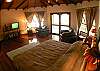 Master Bedroom with King bed, TV, ensuite bathroom, walk-in closet and balcony with view of the pool and beach.  Casa de Somers vacation rental in Esterillos near Jaco and Manuel Antonio.