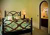 Bedroom 2 (ground floor) with Queen bed and ensuite bathroom, that opens to the courtyard at Villa Antigua luxury vacation rental home in south Jaco beach, Costa Rica