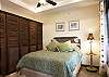 Fourth bedroom with Queen bed and closet with safe box, in the guesthouse at Hermosa Palms Villa La Costa luxury vacation rental in Playa Hermosa, Costa Rica.