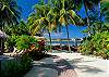 Tropical gardens, white sand and hammocks at Casa Milagro beachfront vacation rental villa in Jaco, Costa Rica