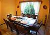 Hardwood dining table with eight contoured chairs at Casa Miguel vacation rental house in Jaco, walking distance to beach and main street.