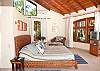 Master Bedroom with King bed, TV, safe, closet and ensuite bathroom at Casa Milagro beachfront vacation rental villa in Jaco, Costa Rica