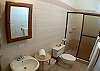 Full bathroom with shower at our Mar Arena vacation rental condo in Jaco, Costa Rica.