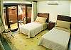 Third bedroom with Twin beds, closet and terrace at La Flor del Paraiso vacation rental home in Jaco's only beachfront single-family home gated community.