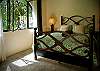 Bedroom 2 (ground floor) with Queen bed and ensuite bathroom, that opens to the courtyard at Villa Antigua luxury vacation rental home in south Jaco beach, Costa Rica