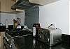Kitchen with professional grade stove/oven and granite countertops at Casa Infinito luxury vacation rental home at Valle Perdido in Playa Hermosa, Costa Rica
