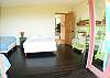 Second bedroom with two double beds and one twin bed and balcony with ocean view at Casa Exotica vacation rental home in Esterillos, Costa Rica near Manuel Antonio and Jaco