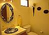 Guest bathroom on first floor with beautifully handcrafted sink and mirror at Casa La Ostra vacation rental house in the exclusive Hermosa Palms beachfront gated community, Playa Hermosa, Costa Rica