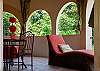Loggia or family room on second floor with open windows and plenty of relaxing furniture, at Villa Antigua luxury vacation rental home in south Jaco beach, Costa Rica