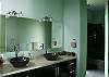 Master Bathroom with double stone sinks and shower with double heads and view of the rainforest at Casa Infinito luxury vacation rental home at Valle Perdido in Playa Hermosa, Costa Rica