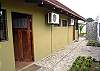 Pool and palm thatched terrace with table for 10 guests and gas grill at Casa Gris vacation rental house in Jaco, Costa Rica