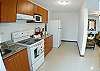 Full kitchen with ceramic top stove and oven, large fridge, microwave, coffemaker and utensils at Costa Linda vacation rental condo 8-7 in Jaco, walking distance to the beach.