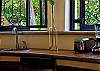 Kitchen counter with double sink and stainless steel appliances at Villa Antigua luxury vacation rental home in south Jaco beach, Costa Rica