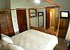 Second Bedroom with Queen bed (quality mattress), TV, closet, dressers and ensuite bathroom at Rio Copey vacation rental in Jaco, walking distance to beach and main street.