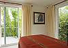 Bedroom 3 has 2 Twin beds that easily convert to a King bed with a special wedge.  The bedroom is on the bottom level and has ensuite bathroom and 3 large windows with views of the rainforest at Casa Infinito luxury vacation rental home at Valle Perdido in Playa Hermosa, Costa Rica