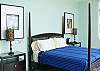 Master Bedroom with panoramic view of the ocean and the rainforest, King Size four poster bed, LCD TV, ensuite bathroom and balcony at Casa Infinito luxury vacation rental home at Valle Perdido in Playa Hermosa, Costa Rica